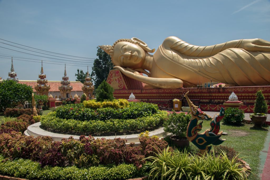 Buddha at the entrance of the Pha That Luang in Vientiane in Laos