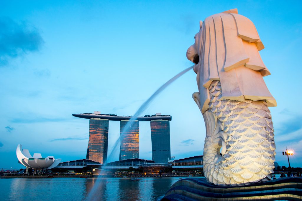 The iconic Marina Bay Sands Hotel in Singapore. In the foreground, the Merlion.